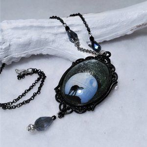 AT-AT on the moon necklace in silver and black.